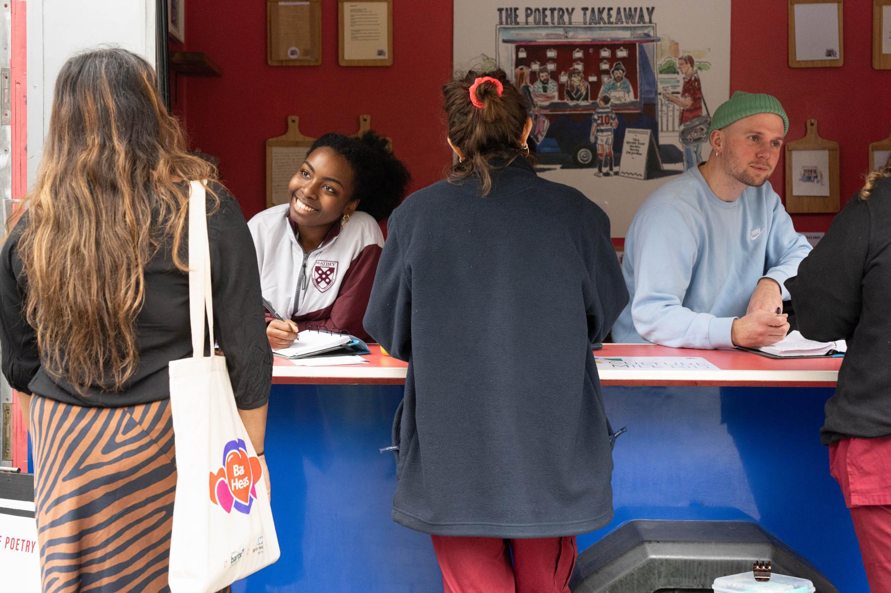 Members of staff visit the poetry takeaway in the square at Barts