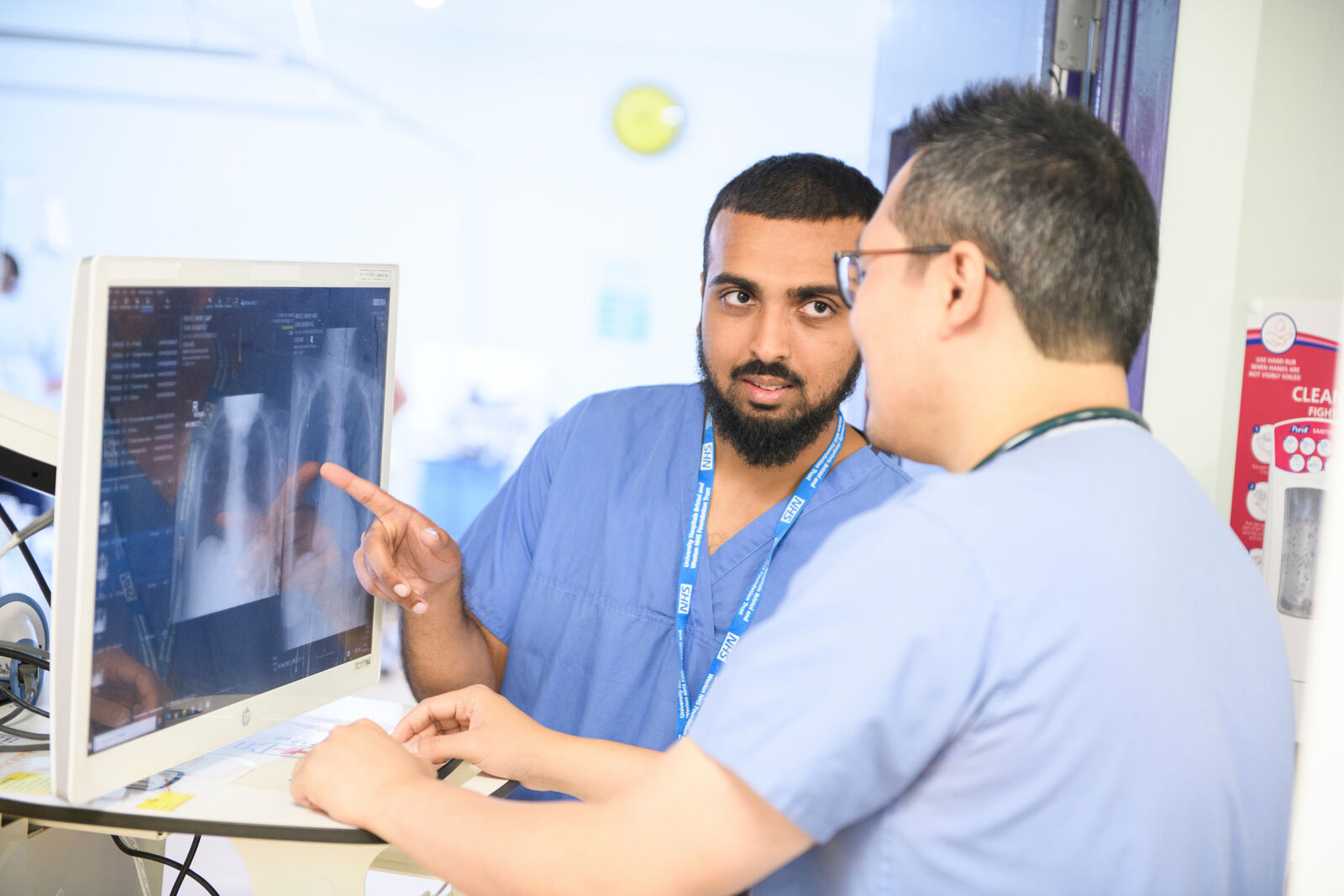 Two clinicians in front of an X-ray at Newham Hospital