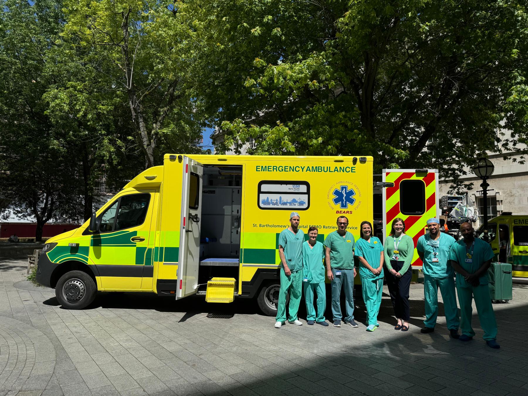 Staff pose outside the ECMO ambulance at St Bartholomew's Hospital